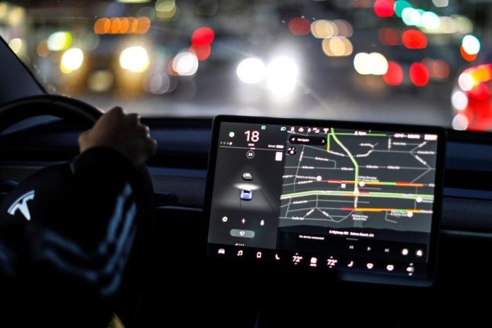 Auto pilot is shown on a 2018 Tesla Model 3 electric vehicle in Solana Beach, California