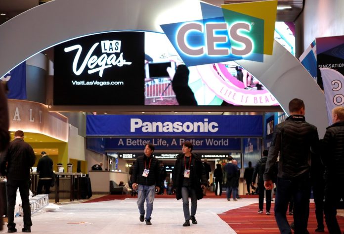 Workers and exhibitors walk through the lobby of the Las Vegas Convention Center as they prepare for the 2020 CES in Las Vegas